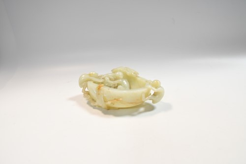 Lot 70 - A Chinese mutton fat jade ape and fruit bowl,  Qing Dynasty, 19th century