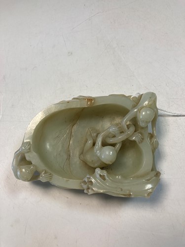 Lot 70 - A Chinese mutton fat jade ape and fruit bowl,  Qing Dynasty, 19th century