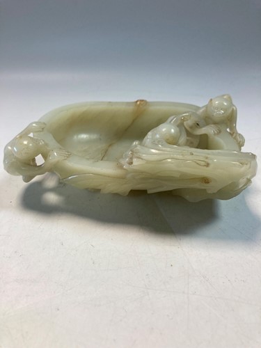 Lot 70 - A Chinese mutton fat jade ape and fruit bowl,  Qing Dynasty, 19th century