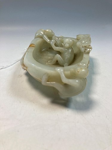 Lot 70 - A Chinese mutton fat jade ape and fruit bowl,  Qing Dynasty, 19th century