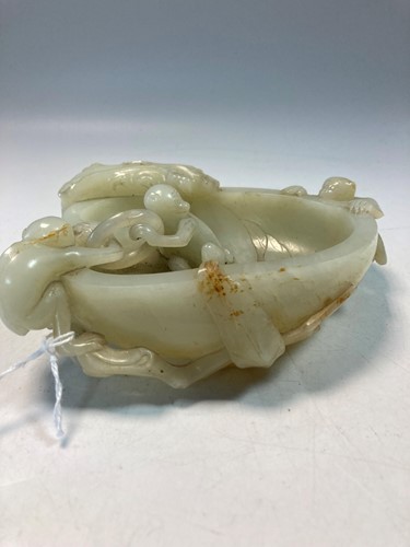 Lot 70 - A Chinese mutton fat jade ape and fruit bowl,  Qing Dynasty, 19th century