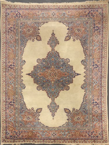 Lot 507 - A sand ground Persian style rug with central...