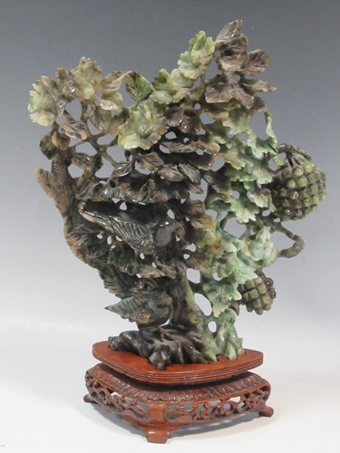 Lot 38 - A carved jade ornament, 30cm high including stand