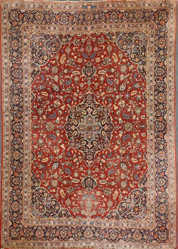 Lot 497 - A large red ground Kashan carpet, with a...