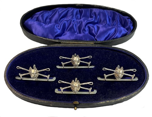 Lot 399 - A cased set of four early 20th century silver novelty menu/place card holders