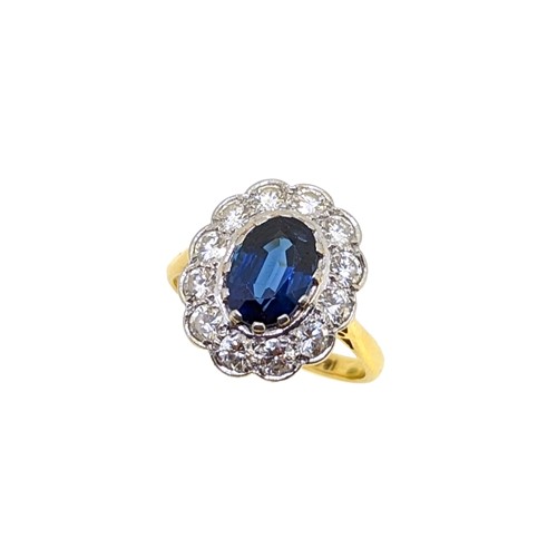 Lot 180 - A sapphire and diamond cluster ring