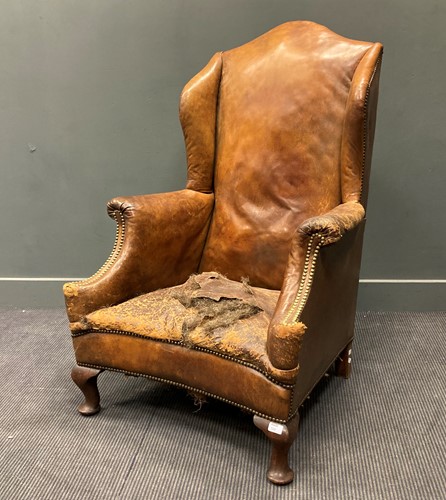 Lot 320 - A George II style wingback armchair