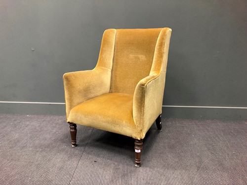 Lot 312 - A mahogany wingback armchair on turned front...