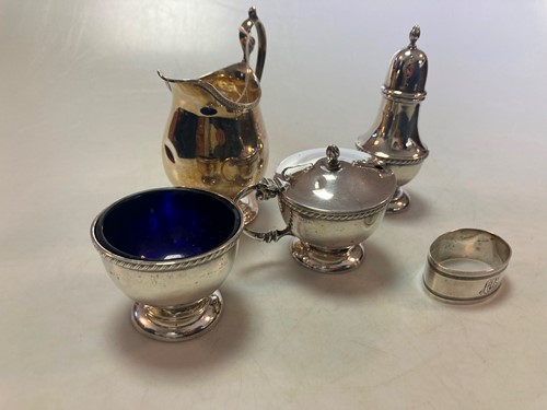 Lot 193 - A silver three piece cruet set with blue glass...