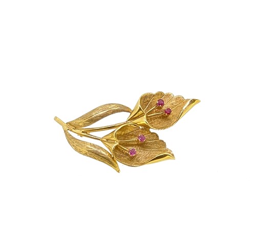 Lot 110 - A ruby set flower brooch