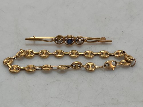 Lot 157 - An anchor link bracelet with a partial '750'...