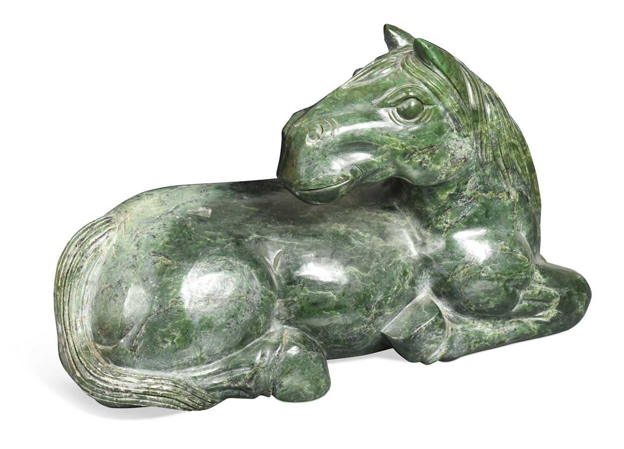 Lot 430 - A Chinese spinach jade type recumbent horse, Ming style