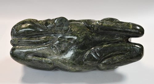 Lot 430 - A Chinese spinach jade type recumbent horse, Ming style