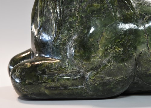 Lot 430 - A Chinese spinach jade type recumbent horse, Ming style