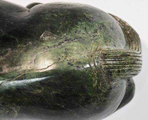 Lot 430 - A Chinese spinach jade type recumbent horse, Ming style