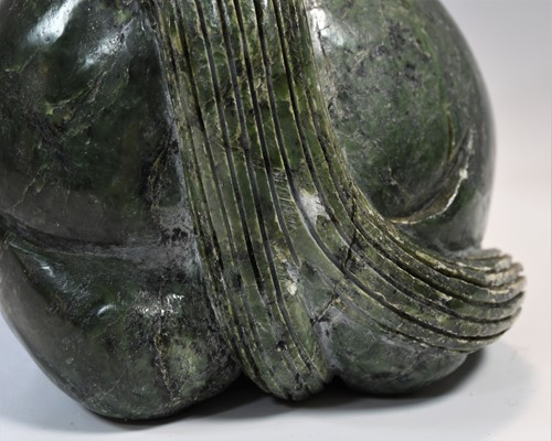 Lot 430 - A Chinese spinach jade type recumbent horse, Ming style
