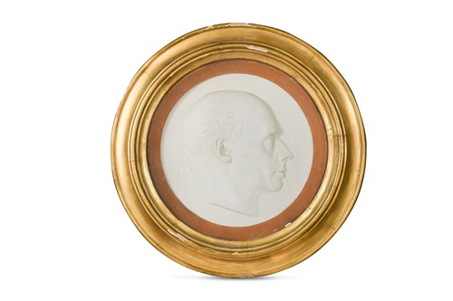 Lot 129A - A high-relief painted plaster profile portrait of a gentleman