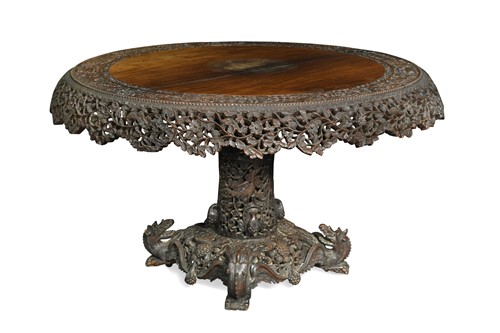 Lot 442 - An Indo-Burmese carved hardwood snap-top circular dining table, circa 1880