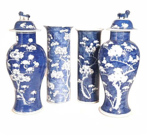 Lot 21 - A near pair of Chinese blue and white prunus and crackled ice baluster vases, Qing Dynasty