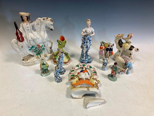 Lot 43 - Staffordshire figures, to include a man on...