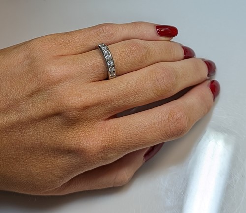 Lot 214 - Tiffany & Co - A diamond set half hoop style ring