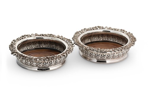 Lot 521 - A pair of George IV silver bottle coasters