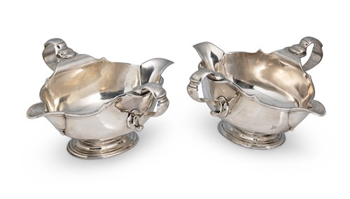 Lot 614 - A pair of George V silver sauce boats of unusual design