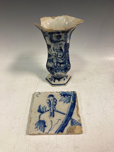 Lot 22 - A Delft tin glazed moulded vase painted with a...