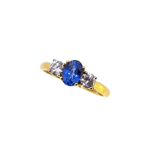 Lot 185 - An 18ct gold sapphire and diamond three stone ring