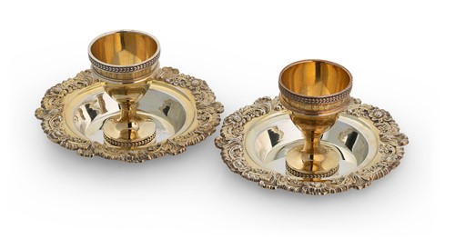 Lot 504 - A pair of George III silver gilt egg cups and accompanying 'saucers'