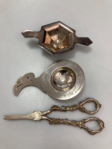 Lot 230 - A pair of silver grape shears, a silver tea...