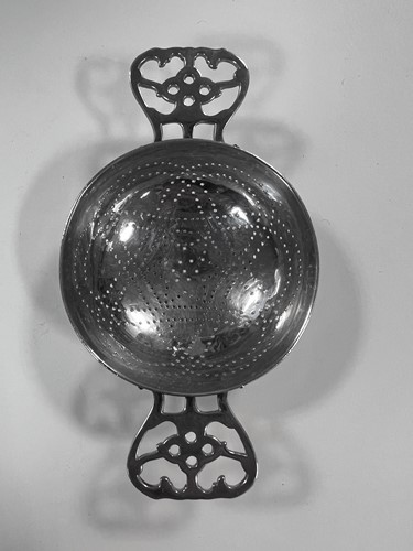 Lot 395 - Two early 20th century silver tea strainers