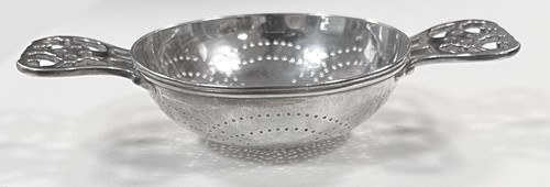 Lot 395 - Two early 20th century silver tea strainers