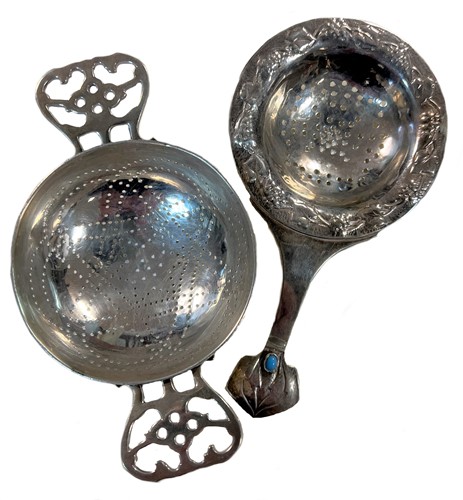 Lot 395 - Two early 20th century silver tea strainers