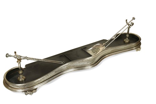 Lot 354 - A polished steel fire fender and matching irons