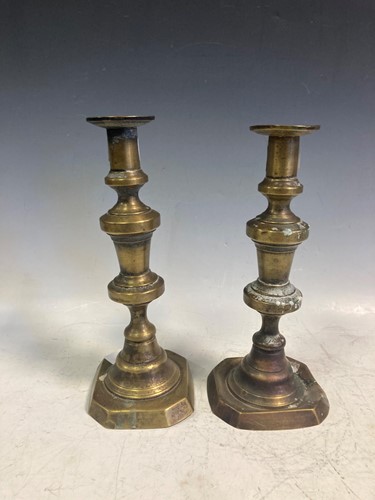 Lot 40 - A pair of George III brass candlesticks with...