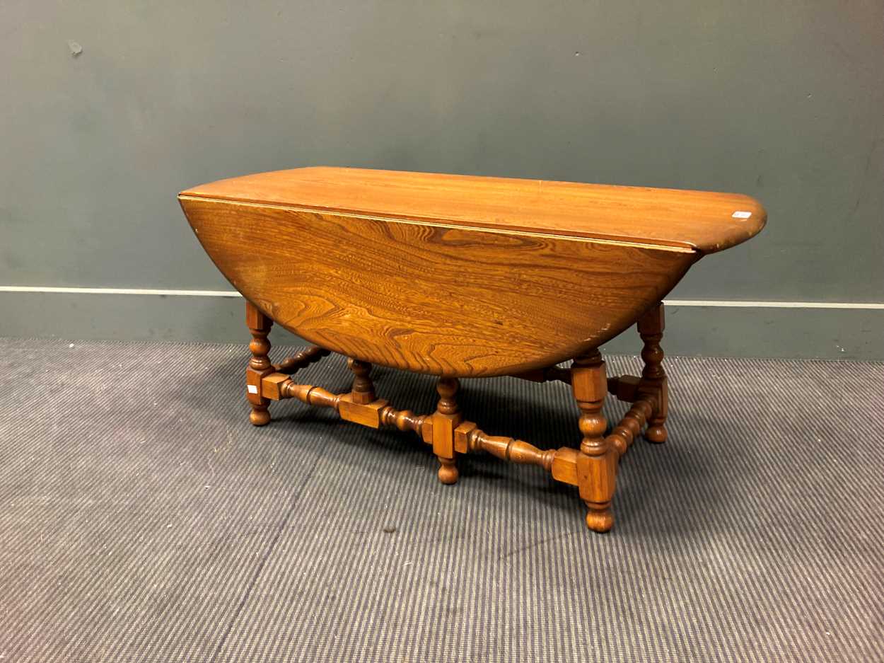 Lot 315 - An Ercol drop leaf coffee table, 49x 107 x