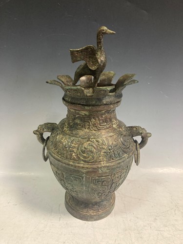 Lot 6 - A Chinese bronze two-handled urn decorated...