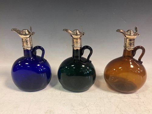 Lot 207 - Three coloured glass claret jugs with silver...