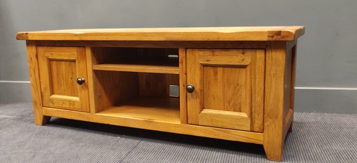 Lot 311A - A low oak side cabinet with cupboard doors...