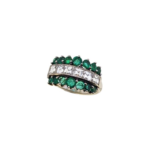 Lot 137 - An emerald and diamond half hoop ring