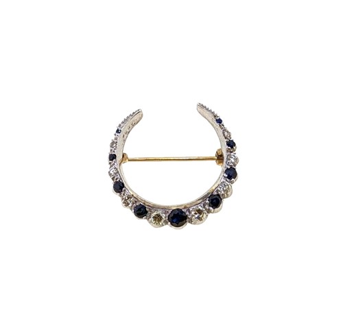 Lot 122 - A late 20th century 9ct gold, sapphire and diamond crescent brooch