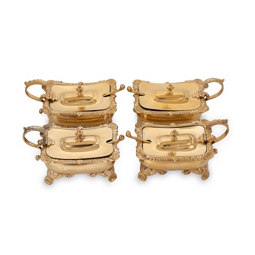 Lot 397 - A set of four Victorian silver gilt mustards with associated spoons