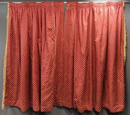 Lot 506 - A pair of red curtains lined with yellow...