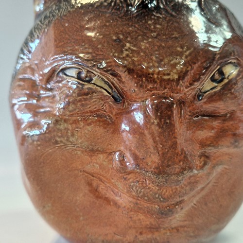 Lot 35 - Robert Wallace Martin for the Martin Brothers, a stoneware double-sided face jug