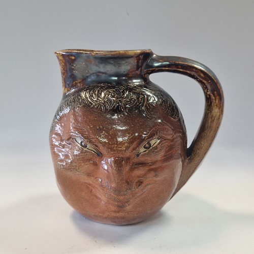 Lot 35 - Robert Wallace Martin for the Martin Brothers, a stoneware double-sided face jug