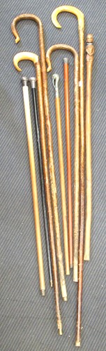 Lot 98 - A collection of walking sticks and canes in a...