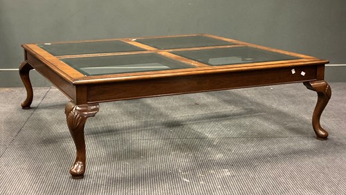 Lot 515 - A modern glass topped coffee table on shell...