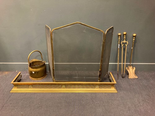 Lot 582 - A pierced brass fender together with a folding...