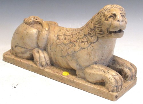 Lot 198 - An alabaster figure of a recumbent lion, in...